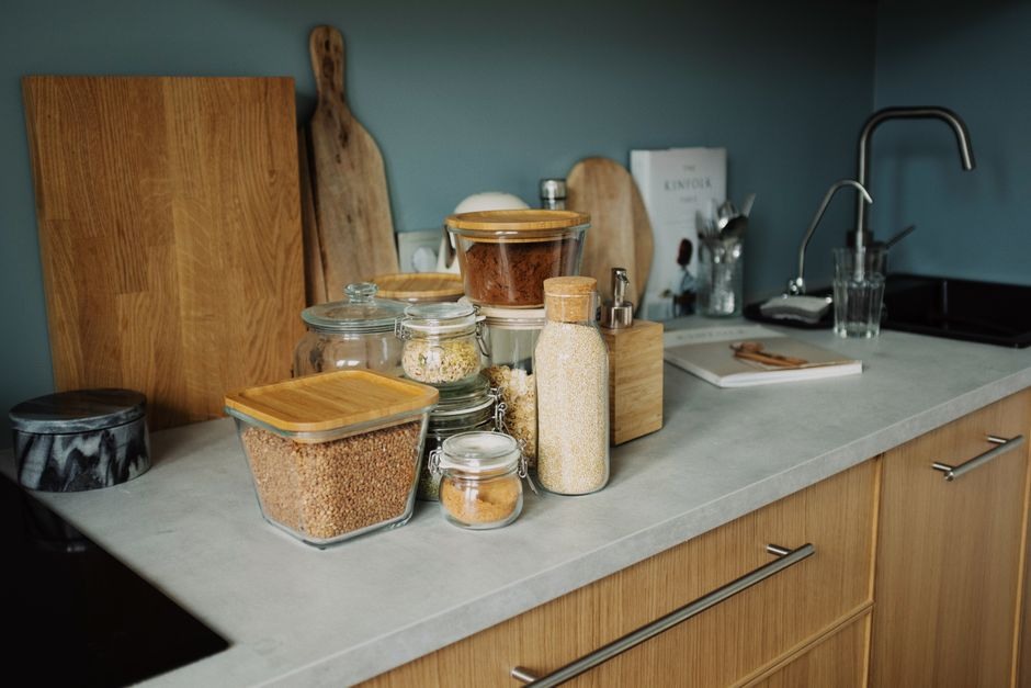 A tidy kitchen counter with everyday ingredients stored in reusable jars.